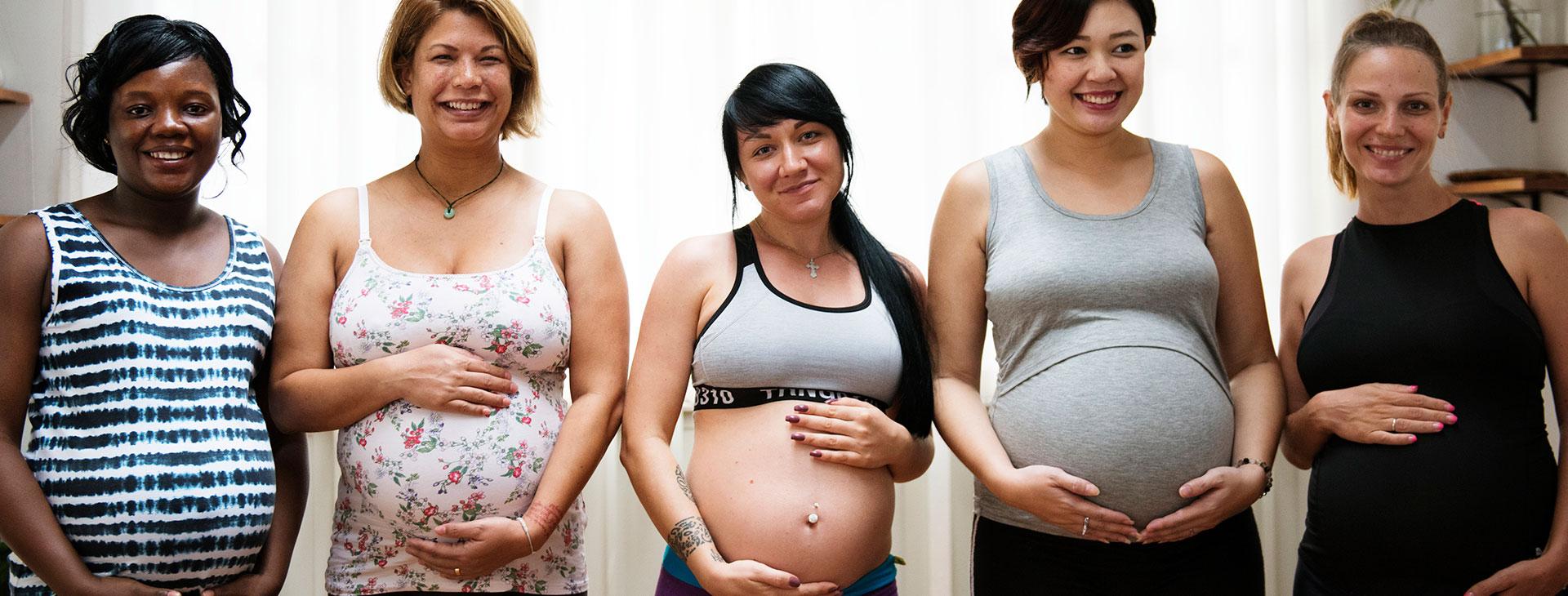 Pregnant Women Embracing Belly Bumps