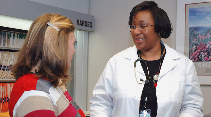A middle-aged white woman at a health consultation with her doctor, a Black woman